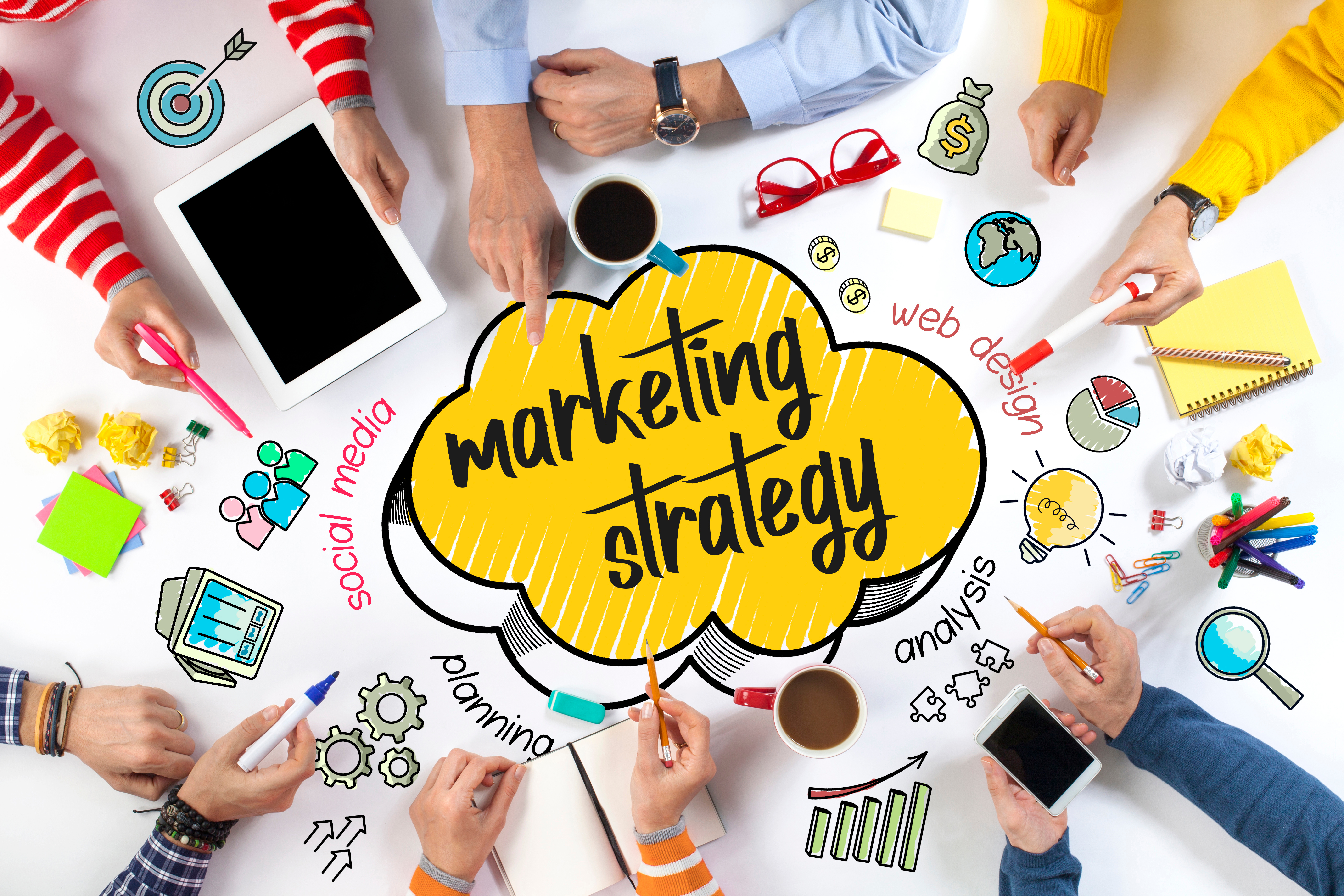 Top view of people working together on a marketing strategy with colorful icons representing social media, planning, web design, and analysis.