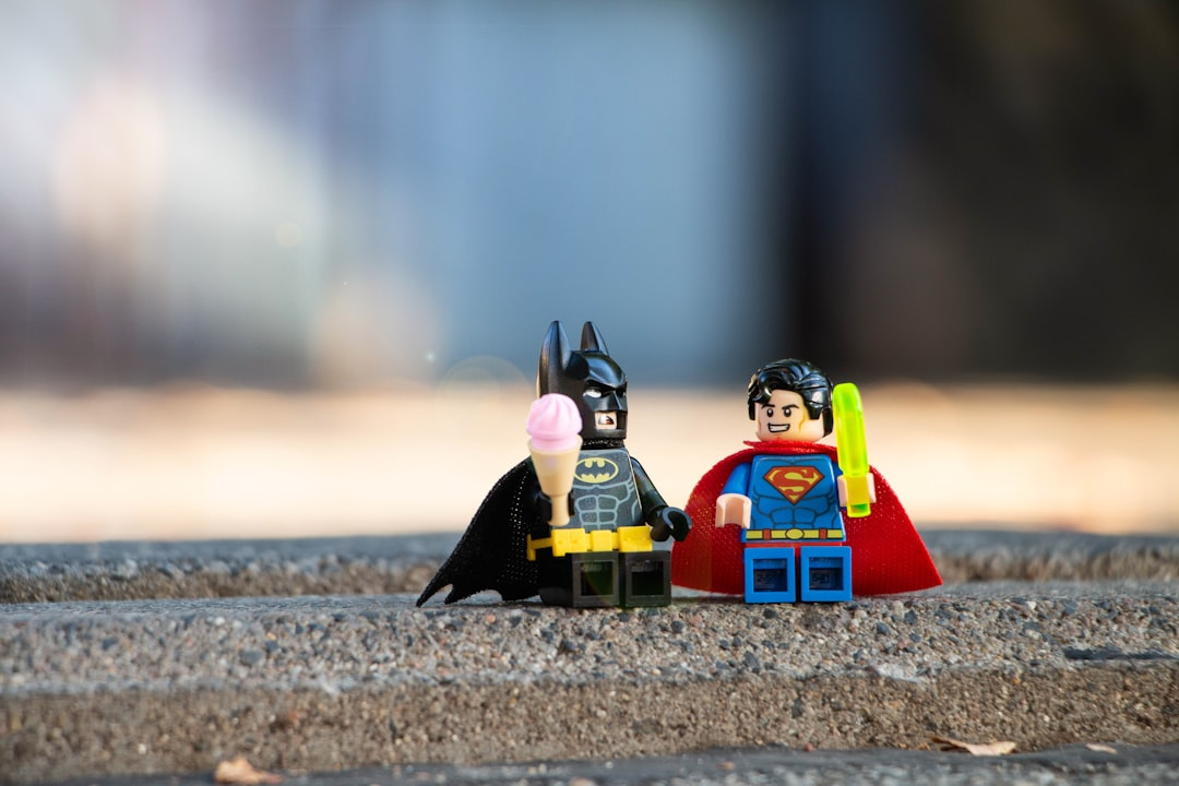 LEGO Batman and Superman figures share a playful moment with ice cream and popsicles, symbolizing how dialogue brings characters to life—featured in the RLA Publishing blog.